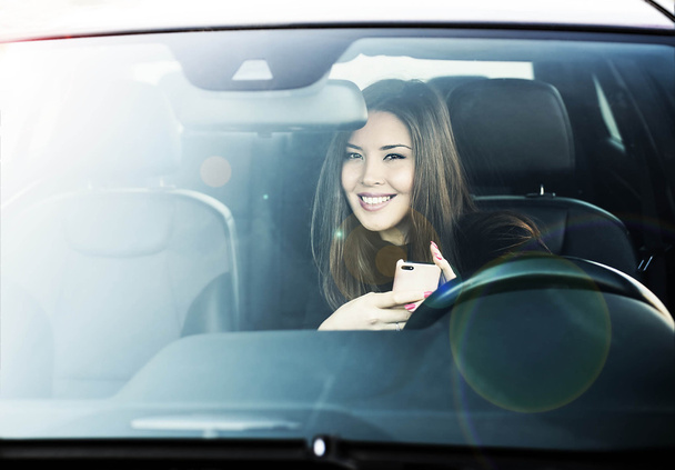 brunette woman sitting on driver seat - Photo, image