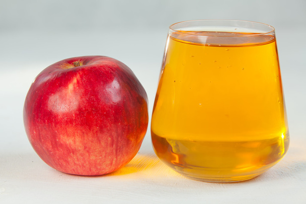 Delicious fresh squeezed apple juice in  transparent glass - Photo, Image