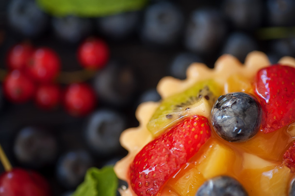 mix of fresh berries and  cheesecake on rustic dark grey wooden  - Photo, Image