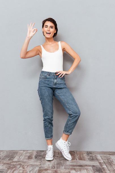 Full length portrait of a girl showing ok sign - Photo, Image