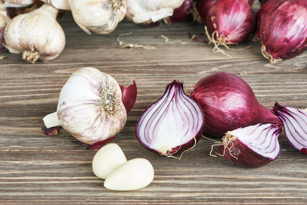 Onions and garlic on table - Valokuva, kuva