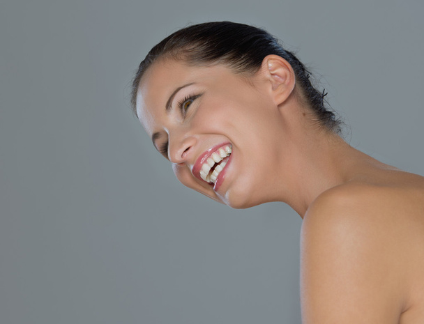 Beauty portrait of smiling girl on gray background - Foto, Bild