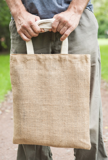 Man holding empty canvas bag. Template mock up - Photo, Image