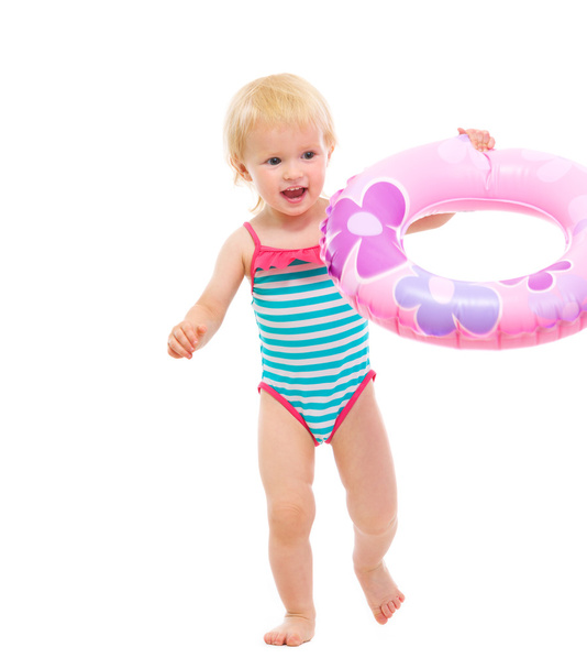 Baby in swimsuit playing with inflatable ring - Foto, immagini