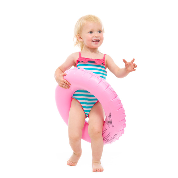 Happy baby in swimsuit with inflatable ring - Фото, зображення