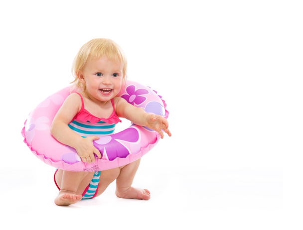Baby girl in swimsuit sitting with inflatable ring - Foto, immagini