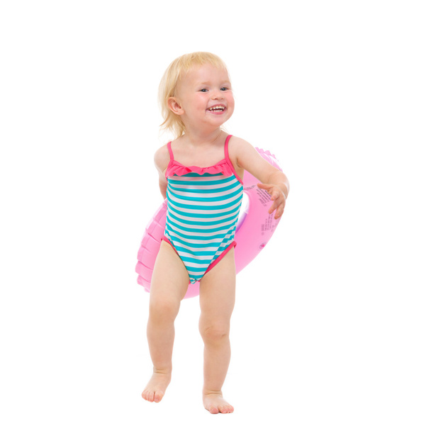 Smiling baby in swimsuit with inflatable ring - Photo, image