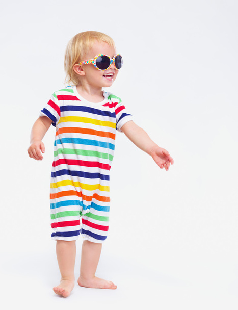 Smiling baby in swimsuit and sunglasses looking on copy space - Fotoğraf, Görsel