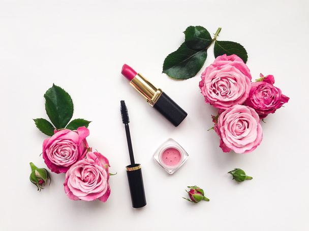 Decorative flat lay composition with cosmetics and flowers - Photo, Image