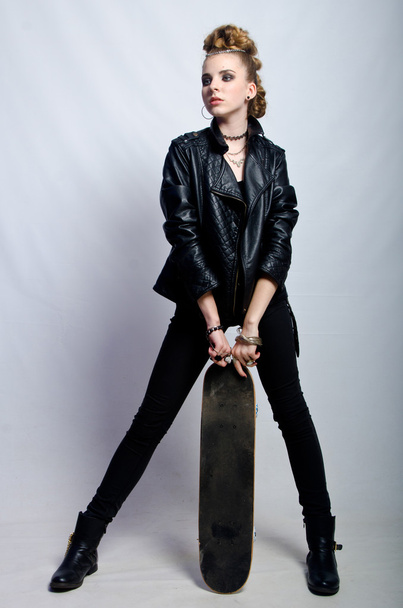 beautiful girl in jacket with a skateboard - Valokuva, kuva