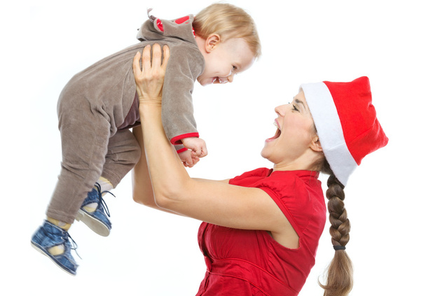 Mother in Santa's hat playing with baby - Foto, imagen