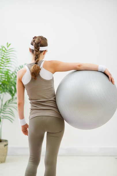 Fitness young woman with fitness ball. Rear view - Фото, изображение