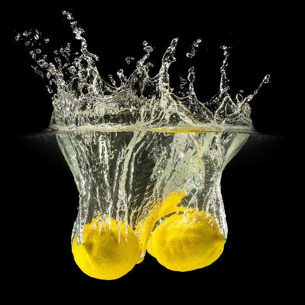 Group of fresh fruits falling in water with splash on black background - Foto, immagini