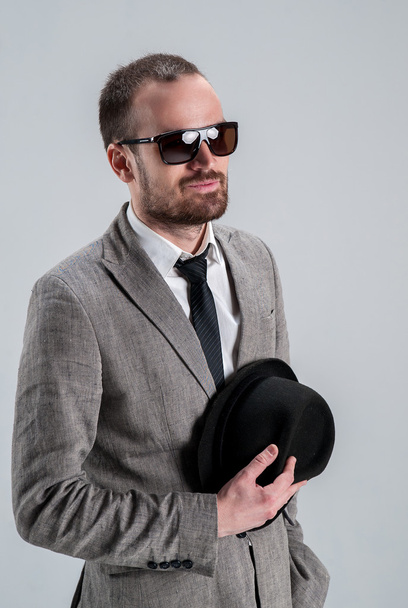 stylish man in a jacket businessman with glasses in his hand hol - Fotoğraf, Görsel