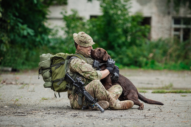 Military Man Hugs Dog - Фото, изображение