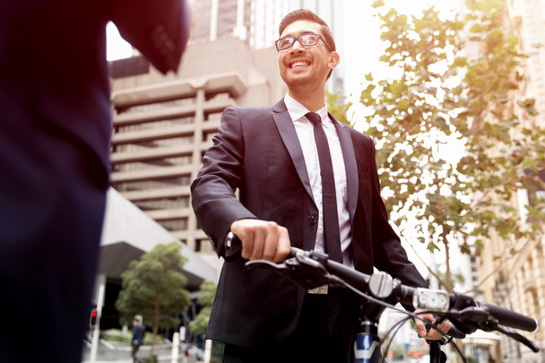 Young businessmen with a bike - Foto, imagen
