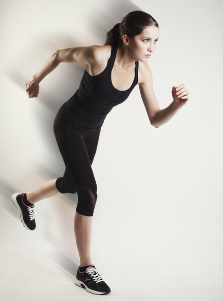 running caucasian woman studio isolated on bg with blur motion s - Fotoğraf, Görsel