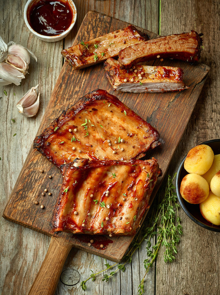 grilled ribs on wooden cutting board - Фото, изображение
