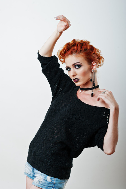 Studio portrait of red haired girl on black blouse and jeans sho - Photo, Image