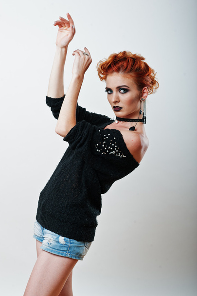 Studio portrait of red haired girl on black blouse and jeans sho - Fotó, kép