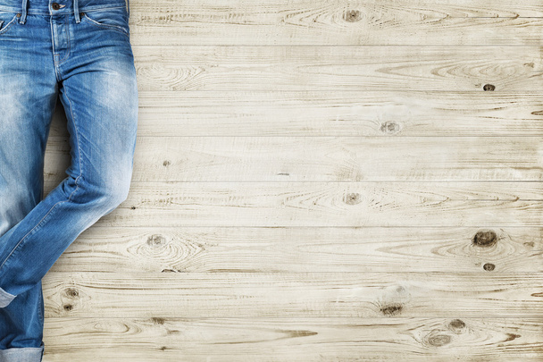 Jeans trouser over white wood planks background - Foto, afbeelding