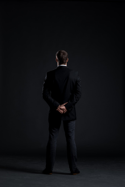 Businessman on black background - Foto, Imagen