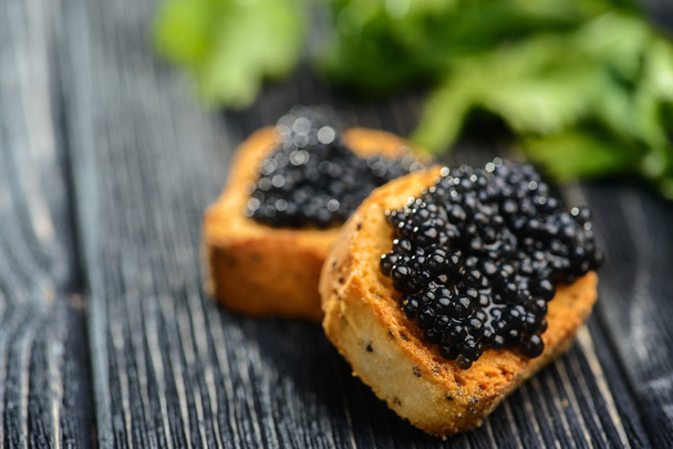 Toasts with black caviar - Фото, изображение