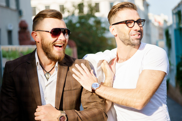 Two cheerful stylish guy met on sunny summer day - Фото, изображение