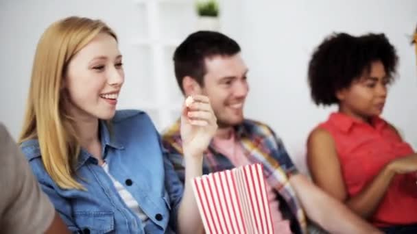 happy friends with popcorn watching tv at home - Video