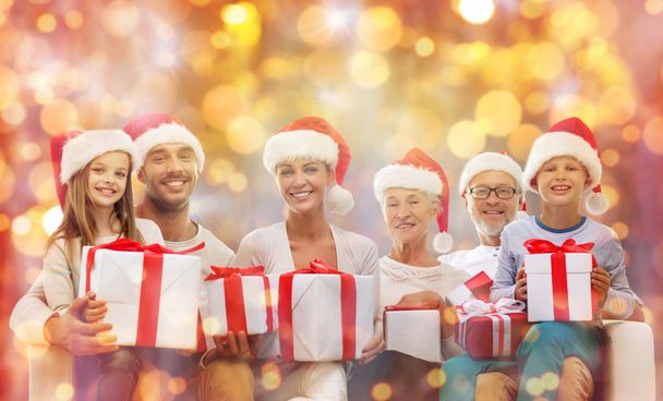 happy family in santa hats with gift boxes - Photo, image