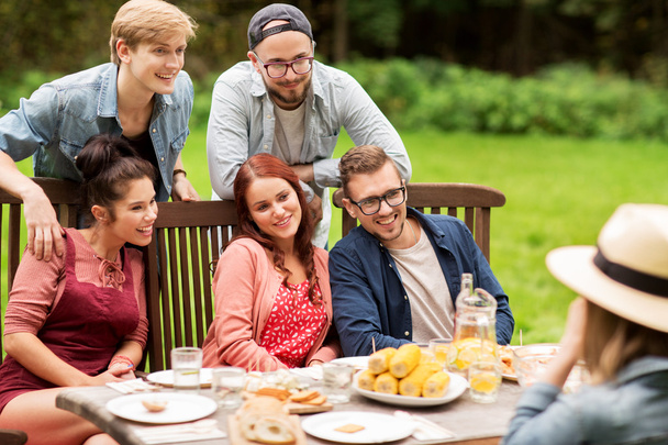 happy friends having dinner at summer garden party - Фото, изображение