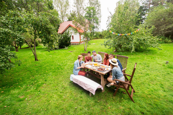 happy friends having dinner at summer garden party - Zdjęcie, obraz