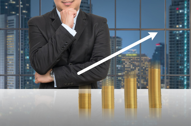 Businessman with gold coins growth up  - Photo, Image