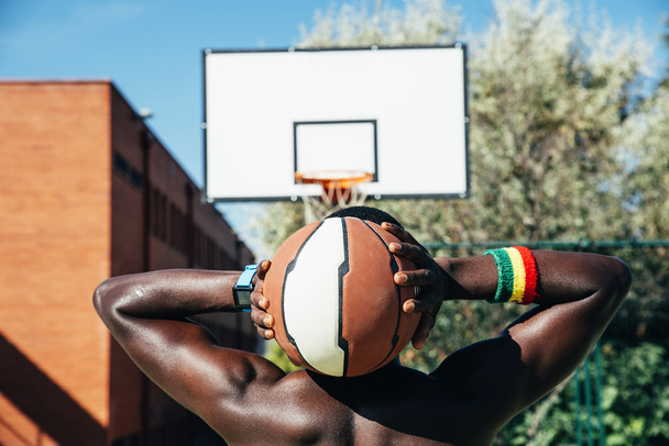 Male basketball player holding a ball. - Fotografie, Obrázek