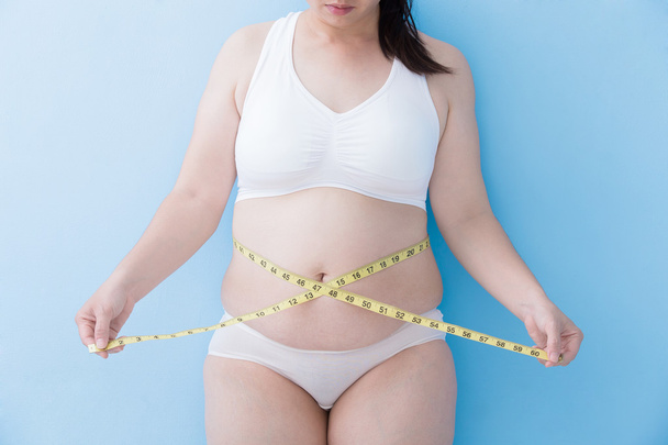 woman measuring  waist with tape - Φωτογραφία, εικόνα