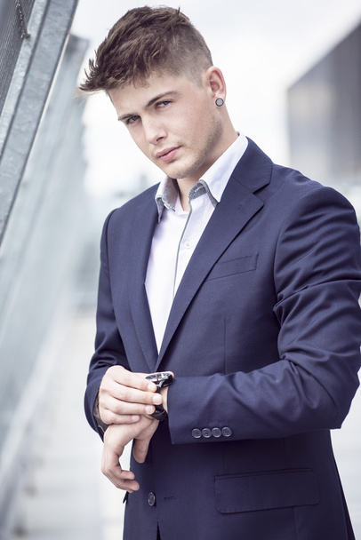 Young handsome man in a blue suit against the city - Photo, Image