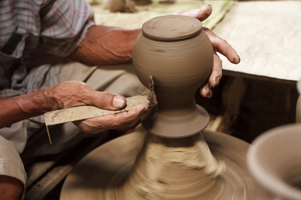 Potter hands making in clay on pottery wheel. - Fotoğraf, Görsel