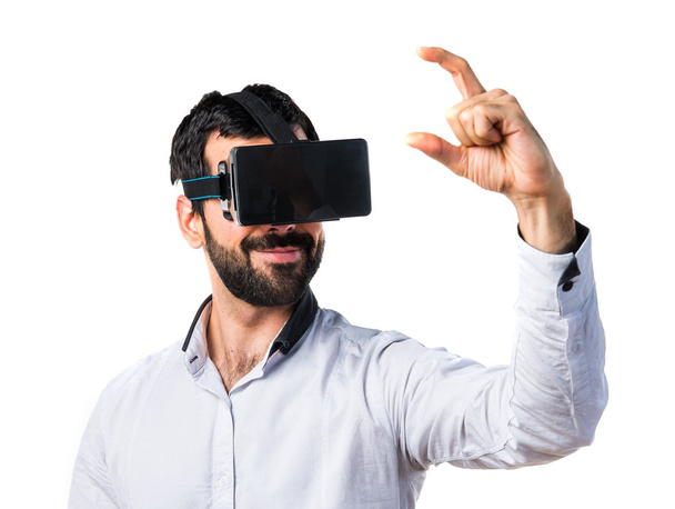 Man using VR glasses holding something - Photo, Image