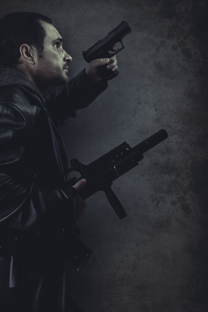 Dangerous man armed with a pistol and machine gun - Valokuva, kuva
