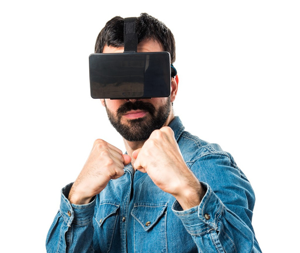 Man using VR glasses giving a punch - Foto, afbeelding