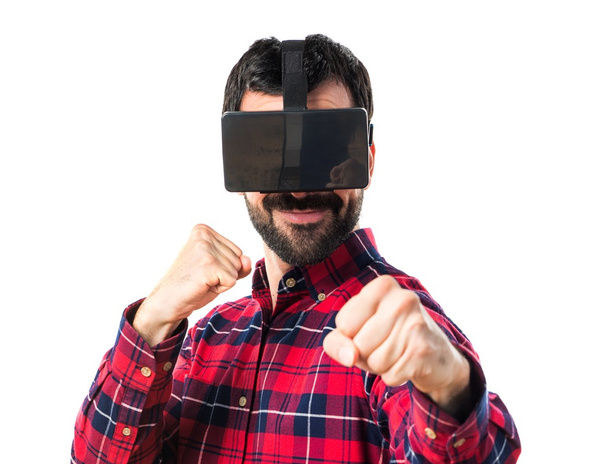 Man using VR glasses giving a punch - Fotó, kép