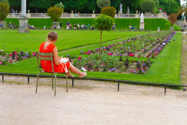 Paris, France, 13.06.2013, woman sitting on a chair and working  - Fotó, kép