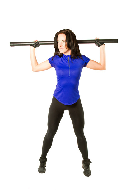 Young woman in sportswear working out in the gym with bodibard on isolate - Photo, image