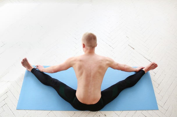 Man practicing yoga. Upavistha konasana. Wide-Angle Seated Forward Bend. - Foto, immagini