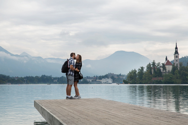 Young couple of tourists in love on the Lake Bled, Slovenia.  - Φωτογραφία, εικόνα