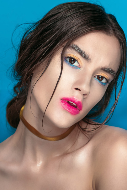 Beauty Girl Portrait with Vivid Makeup. Fashion Woman portrait close up on blue background. Bright Colors. Manicure Make up. Smoky eyes, long eyelashes. Rainbow Colors. Retouched shot - Valokuva, kuva