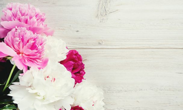 colorful peonies on white wooden surface - 写真・画像