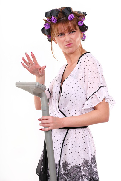 Housewife with vacuum cleaner in hand - Фото, зображення