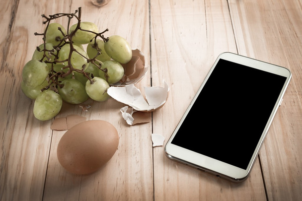 tablet, phone, smartphone, and other food on wooden table - Foto, immagini