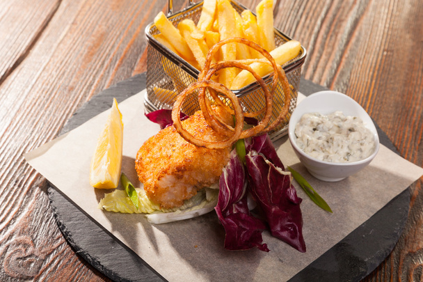 fish with fries and tartar sauce on wooden table - Photo, Image